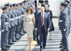  ?? — AFP ?? US President Donald Trump and US First Lady Melania Trump are greeted by an honour guard of Royal Air Force personnel after disembarki­ng Air Force One at Stansted Airport, north of London, on Thursday.