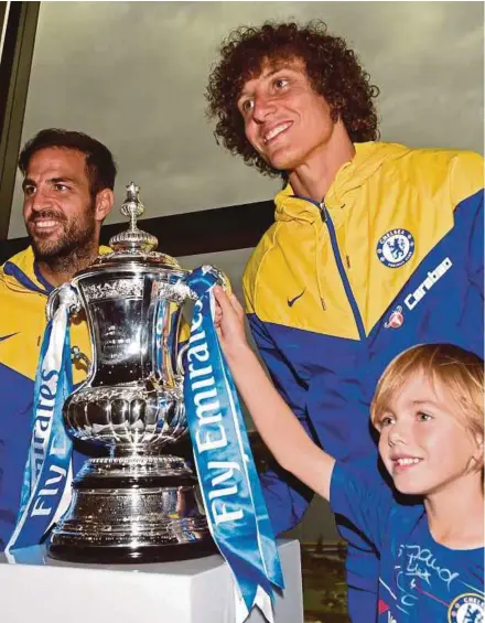  ??  ?? Chelsea’s David Luiz (second from right) and Cesc Fabregas (left) pose with young local fan Ethan Harbison and the FA Cup following a press conference at Optus Stadium in Perth on Friday.