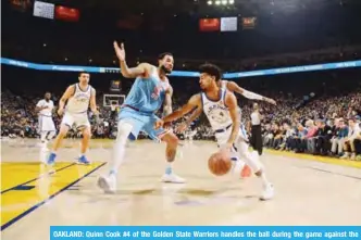  ??  ?? OAKLAND: Quinn Cook #4 of the Golden State Warriors handles the ball during the game against the Sacramento Kings on Friday ORACLE Arena in Oakland, California. — AFP