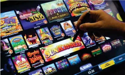  ?? Photograph: Dan Kitwood/Getty Images ?? The government is expected to adopt measures including bet limits of between £2 and £5 on online slot machine and casino games.