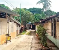  ?? FOLLY AKBAR/JAWA POS ?? BEDA SUASANA: Awiludin dan kentongan yang masih tersisa di Lorong Buangkok (foto kanan). Salah satu sudut kampung. Bangunan dan tradisi di sini bisa dibilang kontras dengan Singapura, negeri kota yang megah dan gemerlap.