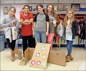  ??  ?? Calhoun fourth graders created ‘Crash-the-Ornament,’ a skee ball style arcade game, using tools found around the classroom on STEM Day.