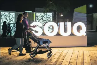  ?? Mona Al Marzooqi / The National ?? Parents and child stroll into the Souq on day one of the festival.