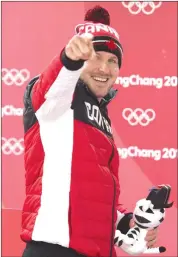  ?? THE CANADIAN PRESS/JONATHAN HAYWARD ?? Canadian Justin Kripps celebrates his and teammate Alexander Kopacz's gold medal tie with Germany in the two-man bobsled at the Pyeongchan­g 2018 Winter Olympic Games in South Korea, Monday, Feb. 19, 2018.