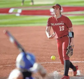  ?? OU’s Nicole May (19) throws a pitch during a 9-0 win against Tulsa on April 6 at Marita Hynes Field in Norman. SARAH PHIPPS/THE OKLAHOMAN ??