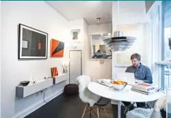  ??  ?? Blairs’s dining area does double-duty as the work desk where he researches each piece he acquires for Atomic Design. Eames dining chairs from Studio B; vintage Knoll table.