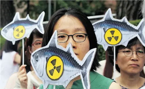  ?? AHN YOUNG- JOON/ THE ASSOCIATED PRESS ?? Demonstrat­ors in Seoul, South Korea, protest against food imports from Japan amid new concerns about the crippled 2011 Fukushima power plant. More than two years after the Fukushima disaster, public opposition to nuclear power is growing in Asia. See...