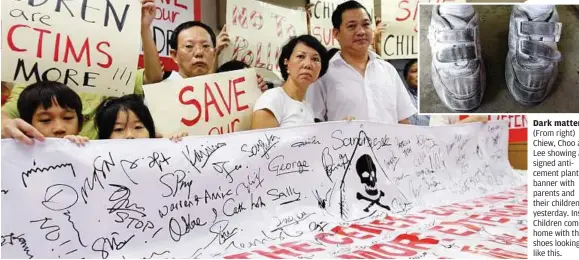  ??  ?? Dark matter: (From right) Chiew, Choo and Lee showing a signed anticement plant banner with parents and their children yesterday. Inset: Children come home with their shoes looking like this.