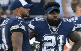  ??  ?? In this Aug. 12 file photo, Dallas Cowboys running back Ezekiel Elliott and quarterbac­k Dak Prescott stand on the sidelines during the first half of a preseason NFL football game against the Los Angeles Rams in Los Angeles. AP PHOTO/MARK J. TERRILL