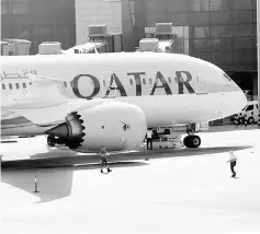  ??  ?? A Qatar Airways aircraft is seen at Hamad Internatio­nal Airport in Doha, Qatar. Qatar Airways will back Meridiana to be Italy’s top airline, supplying it with wide and narrow bodied jets to help expand its network, the Middle East carrier’s chief...