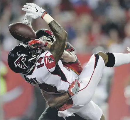  ?? JASON BEHNKEN/THE ASSOCIATED PRESS ?? Atlanta wide receiver Justin Hardy loses the football after getting hit by Tampa Bay Buccaneers free safety Chris Conte on Monday night in Tampa, Fla. The Falcons won 24-21.
