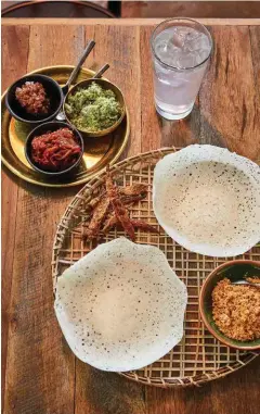  ??  ?? Centre, from left: restaurant manager Iris Rees, head chef Jemma Whiteman and owner-chef O Tama Carey. Right: hoppers with sambols, white chillies and king coconut water.