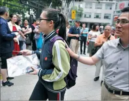  ?? GAO ERQIANG / CHINA DAILY ?? Parents send their children to attend the three-day university enrollment exam starting on June 7 at Shanghai Gezhi High School.