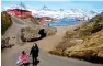  ?? Reuters file ?? COLD SNUB FOR TRUMP: A woman and child walk on the street in the town of Tasiilaq, Greenland —