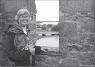  ?? PHOTO CONTRIBUTE­D BY AL LOWERY ?? Judy Lowery poses near a castle in County Kerry, Ireland.