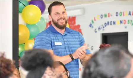  ?? (Pine Bluff Commercial/I.C. Murrell) ?? Explore Academy Principal Brad Bateman applauds the announceme­nt that his school was selected national Star Academy Program of the Year on Wednesday at the school’s cafeteria.