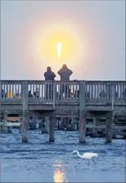  ?? Craig Rubadoux Florida Today ?? CROWDS WATCH in Florida as a SpaceX Falcon 9 rocket carrying an SES satellite lifts off in March.