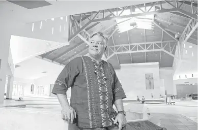  ?? Jerry Baker ?? Father Norbert Maduzia stands in the nave of St. Ignatius of Loyola Catholic Church, which has been under constructi­on for months due to major flood damage sustained during Hurricane Harvey last September. The Spring congregati­on has been gathering for...