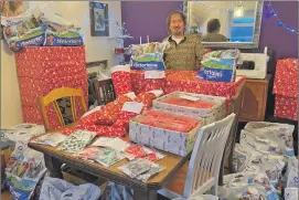  ??  ?? Mark Alecock of MEA Furniture and Crafts with just some of the gifts to be sent to schoolchil­dren on Mull.