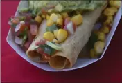  ?? ?? Build-your-own potato taquitos come with chicken or birria at Casa Modelo at Angel Stadium.