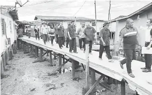  ??  ?? KEMUDAHAN: Rozman (tiga kanan) melawat pembinaan jambatan simen di Kampung Bebuloh Laut, baru-baru ini.