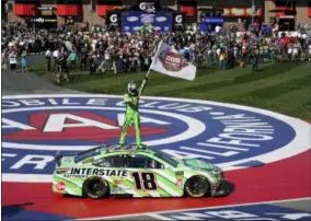  ?? RACHEL LUNA — THE ASSOCIATED PRESS ?? Kyle Busch stands on his car after winning the Monster Energy Cup Series race March 17 at Auto Club Speedway in Fontana, Calif.