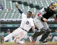  ?? DUANE BURLESON — THE ASSOCIATED PRESS ?? Detroit Tigers’ Daz Cameron scores behind Chicago White Sox catcher Yasmani Grandal during the fourth inning of Tuesday’s game in Detroit.