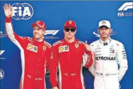  ?? GETTY IMAGES ?? Top three qualifiers Kimi Raikkonen (centre) of Ferrari, Sebastian Vettel (left) also of Ferrari and Lewis Hamilton of Mercedes celebrate after Italian Grand Prix’s qualifying at Monza on Saturday.