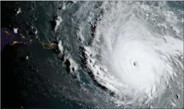  ?? NOAA VIA AP ?? In this geocolor image captured by GOES-16 and released by the National Oceanic and Atmospheri­c Administra­tion, Hurricane Irma, a potentiall­y catastroph­ic category 5 hurricane, moves westward, Tuesday morning in the Atlantic Ocean toward the Leeward...