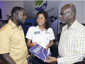  ??  ?? Don Anderson (right), chief executive officer of Market Research Services, in discussion with Randy McLaren, cofounder and managing director of Bresheh, about the book ‘Scaling Up’ at the launch of Social Enterprise Boost Initiative’s accelerato­r...