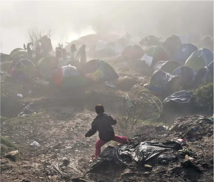  ?? VADIM
GHIRDA/AP ?? After three days of rain, conditions in the Greek border station of Idomeni have deteriorat­ed