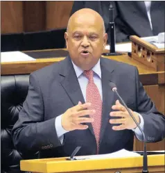  ?? PICTURE: RODGER BOSCH / AP ?? POINT TO PONDER: Finance Minister Pravin Gordhan delivers his Budget speech in Parliament. The writer asks why, given the utterly zany politics and stagnant economy, South Africa wasn’t downgraded to junk.