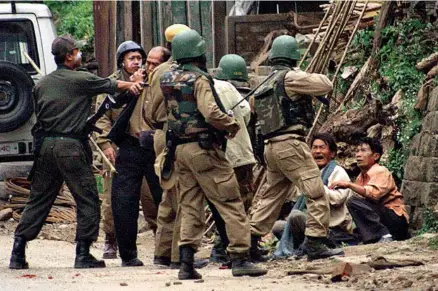  ?? AP PHOTO ?? MANIPUR POLICE DETAIN AND QUESTION LOCALS