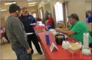  ?? LAUREN HALLIGAN — DIGITAL FIRST MEDIA ?? Paul Greenberg of Brunswick serves his chili to event-goers at the 2019 Brunswick Elks Lodge Chili Challenge.