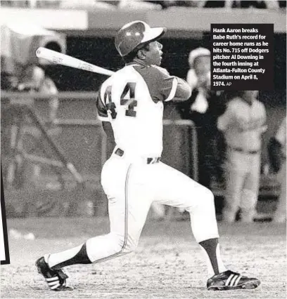  ?? AP ?? Hank Aaron breaks Babe Ruth’s record for career home runs as he hits No. 715 off Dodgers pitcher Al Downing in the fourth inning at Atlanta-Fulton County Stadium on April 8, 1974.