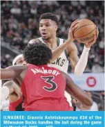  ?? —AFP ?? ILWAUKEE: Giannis Antetokoun­mpo #34 of the Milwaukee Bucks handles the ball during the game on March 19, 2023.