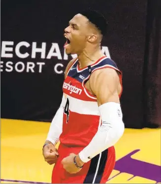  ?? Luis Sinco Los Angeles Times ?? RUSSELL WESTBROOK celebrates after scoring and getting fouled during the Wizards’ 127-124 win over the Lakers in overtime. He and Bradley Beal combined for all 12 Washington points in OT.