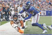  ??  ?? Broncos tight end Albert Okwuegbuna­m, left, dives for a touchdown as Giants cornerback James Bradberry attempts to stop him during the second half.