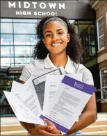  ?? PHIL SKINNER FOR THE ATLANTA JOURNAL-CONSTITUTI­ON ?? Westlake High School senior Makenzie Thompson (left) proudly holds her recruitmen­t letter from Tuskegee University, while Midtown High School senior Taylor Edwards shows off some of her college acceptance letters. Both Atlanta area seniors have big plans.