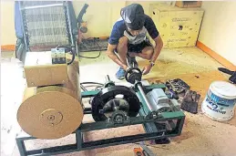  ??  ?? Mr Arthit shows his knack for mechanical work as he assembles parts of a tractor and equips it with a remote-control panel.