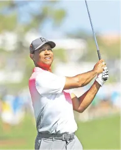  ?? — AFP photo ?? Tiger Woods plays a shot on the fourth hole during the second round of the Honda Classic at PGA National Resort and Spa on February 23, 2018 in Palm Beach Gardens, Florida.