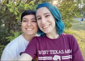  ?? The Associated Press ?? This recent photo shows El Johnson, right, with her girlfriend, Sara Goodie, in Austin, Texas. Johnson has decided not to bear children, though she hasn’t ruled out adoption.