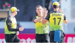  ?? AP ?? Australia’s Adam Zampa (centre) is congratula­ted by teammate Marcus Stoinis (right) after taking the wicket of Bangladesh’s Shamim Hossain during the Cricket Twenty20 World Cup match against Bangladesh in Dubai, United Arab Emirates, yesterday.