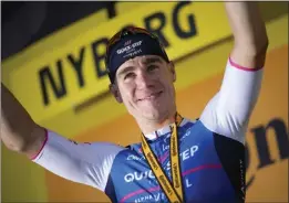  ?? DANIEL COLE – THE ASSOCIATED PRESS ?? Stage 2 winner Netherland­s' Fabio Jakobsen celebrates on the podium following Saturday's 125.8 mile trek from Roskilde to Nyborg, Denmark at the Tour de France.