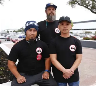  ?? GARY REYES, BAY AREA NEWS GROUP ?? Tesla workers Mikey Catura, left, Branton Phillips, centre, and Hai Nguyen, have voiced concerns about workplace safety and wages as the company ramps up production of the new Model 3.