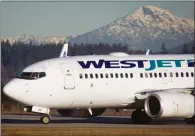  ?? CP FILE PHOTO ?? The union that represents WestJet and WestJet Encore pilots says it has filed an unfair labour practice complaint over the airline’s recruitmen­t of pilots for Swoop, the new ultra-low-cost airline slated to begin flying in June.