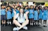  ??  ?? Making a splash: On her way to 200m backstroke gold in 2012 (right) and at a Laureus swim clinic in Sri Lanka (above)