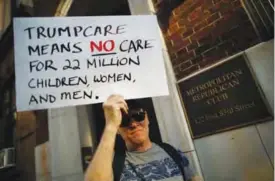  ?? —AFP ?? NEW YORK: A small group of activists rally against the GOP health care plan outside of the Metropolit­an Republican Club in New York City.