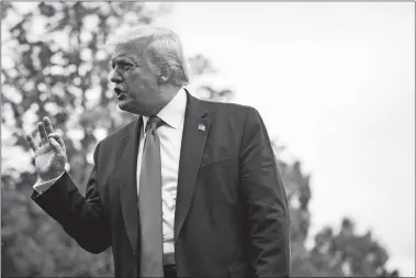  ?? JABIN BOTSFORD/WASHINGTON POST ?? President Donald Trump stops to talk to reporters as he walks to board Marine One and depart from the South Lawn at the White House on Friday.