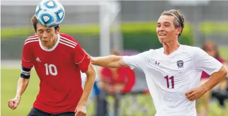  ?? STAFF PHOTO BY C. B. SCHMELTER ?? Signal Mountain’s Max Gray heads the ball while being defended by Alcoa’s Logan Hickey during their Division I-A quarterfin­al match Tuesday at Richard Siegel Soccer Park in Murfreesbo­ro. Signal Mountain won 1-0.